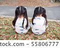 Twin women back view sitting on fallen leaves 55806777
