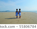 Twin girls back view on beach heart 55806784