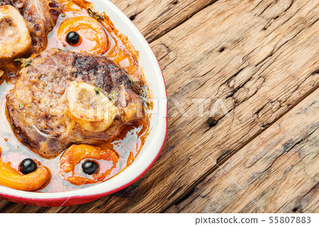 Meat cooked in apricot sauce Meat cooked in apricot sauce 55807883