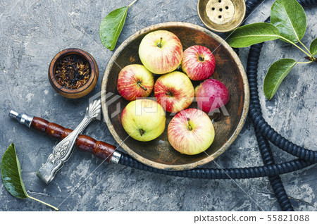 Smoking hookah with apple Smoking hookah with apple 55821088