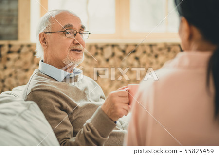 Old grey-haired man having pleasant time with his female friend 55825459