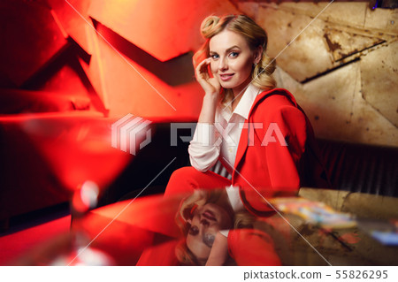 Photo of blonde woman sitting on leather sofa in nightclub 55826295