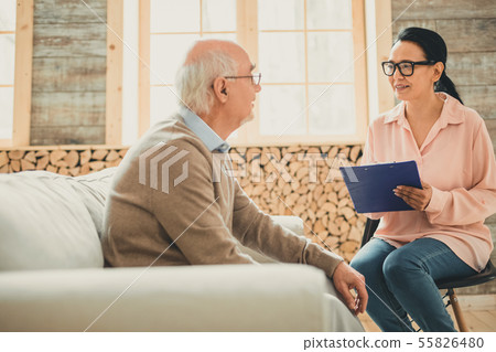 Pretty woman in pink blouse working with pensioner 55826480