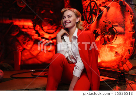 Photo of happy blonde in red jacket in nightclub 55826518