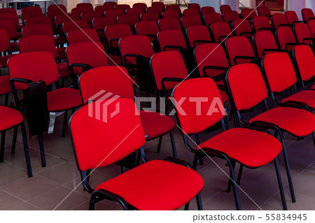 Conference room with a red stage and chairs Conference room with a red stage and chairs 55834945