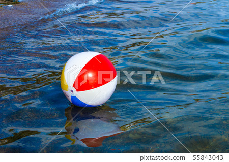 Beach inflatable ball floating in the water Beach inflatable ball floating in the water 55843043