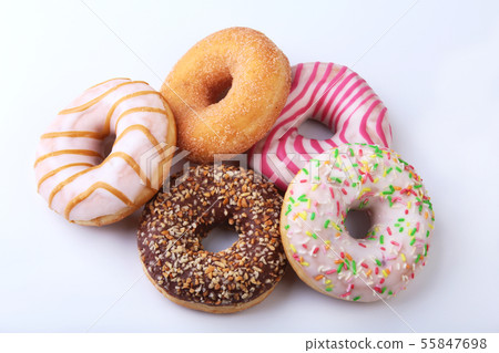 assorted delicious homemade doughnuts in the glaze, colorful sprinkles and nuts isolated on white 55847698