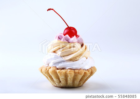 Tasty Homemade cupcake, muffin with cream and cherry. Close up view delicious sweet dessert isolated 55848085