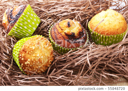 Wicker basket with assorted delicious homemade cupcakes with raisins and chocolate. Cupcakes. Top Wicker basket with assorted delicious homemade cupcakes with raisins and chocolate. Cupcakes. Top 55848720