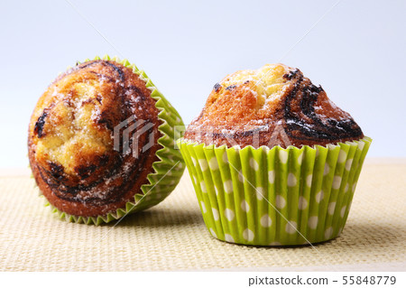 Assorted with Delicious homemade cupcakes with raisins and chocolate isolated on white background Assorted with Delicious homemade cupcakes with raisins and chocolate isolated on white background 55848779