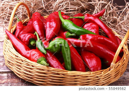 Wicker basket full of fresh red chili peppers. Wicker basket full of fresh red chili peppers. 55849562