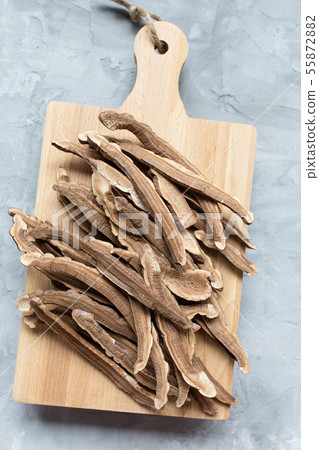 Slices of dried lingzhi mushroom on a board 55872882