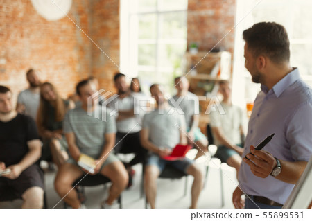 Male speaker giving presentation in hall at university workshop Male speaker giving presentation in hall at university workshop 55899531