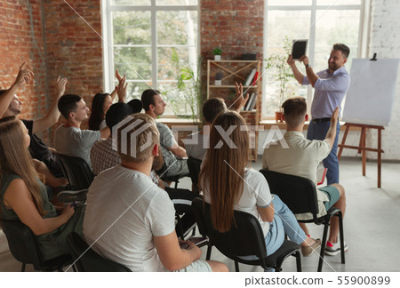 Male speaker giving presentation in hall at university workshop Male speaker giving presentation in hall at university workshop 55900899