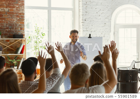 Male speaker giving presentation in hall at university workshop Male speaker giving presentation in hall at university workshop 55901589