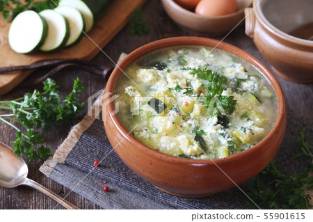 Italian cuisine. Stracciatella zucchini soup 55901615