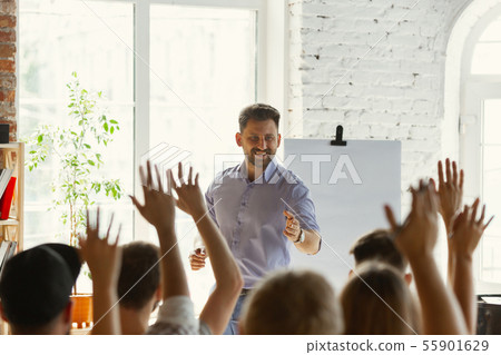 Male speaker giving presentation in hall at university workshop Male speaker giving presentation in hall at university workshop 55901629
