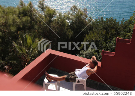 man, basking in the white dress on the balcony man, basking in the white dress on the balcony 55902248