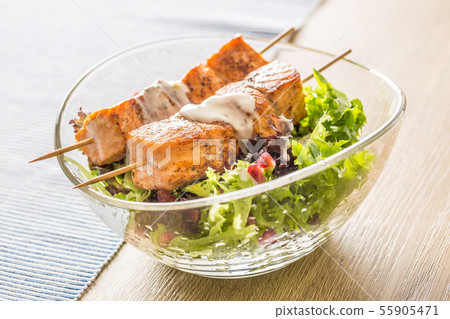 Grilled salmon skewers with summer lettuce salad 55905471