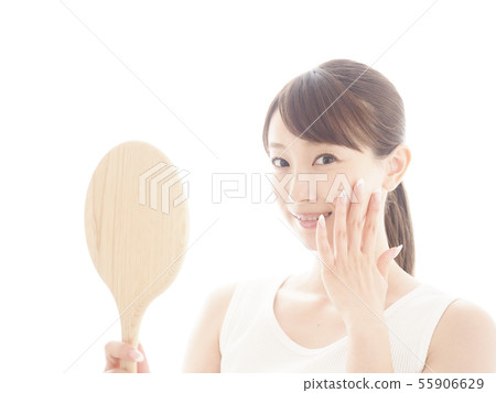 Smiling woman holding a mirror Smiling woman holding a mirror 55906629