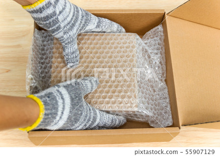 hand of man hold bubble wrap, for protection 55907129