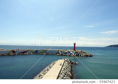 South Korea, Whale Fire Beach in Yeongdeok, Blue Sky and Sea, Red Lighthouse on Breakwater South Korea, Whale Fire Beach in Yeongdeok, Blue Sky and Sea, Red Lighthouse on Breakwater 55907421