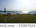 South Korea Eugene, shining morning sea and bench set on the lawn 55907424