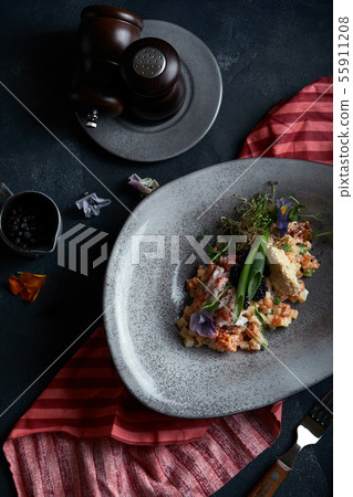 Olivier with crab meat in a beautiful bowl in the form of oysters, on a dark background. Food photo Olivier with crab meat in a beautiful bowl in the form of oysters, on a dark background. Food photo 55911208