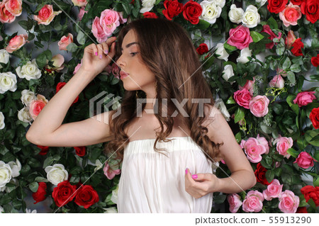 Girl in white dress on floral background 55913290