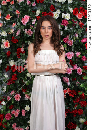 Girl in white dress on floral background 55913320