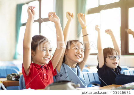 Smiling elementary school kids in classroom Smiling elementary school kids in classroom 55916671