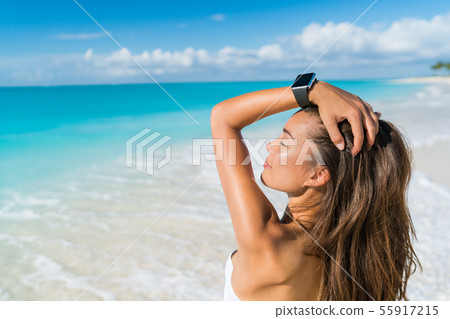 Smartwatch beach woman relaxing with wrist watch 55917215