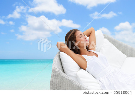 Sleeping woman relaxing lounging on a outdoor sofa Sleeping woman relaxing lounging on a outdoor sofa 55918064