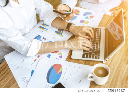 Business team work analyzing charts and graphs Business team work analyzing charts and graphs 55918287