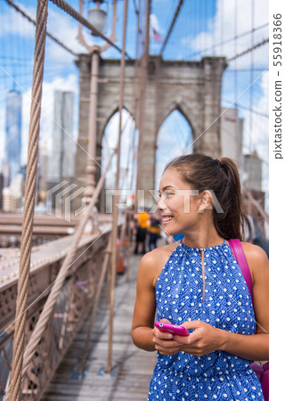 Smartphone woman on Brooklyn bridge New York Smartphone woman on Brooklyn bridge New York 55918366