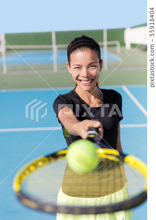 Tennis girl showing racquet and ball on court 55918404