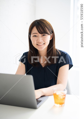 Young woman using a personal computer Young woman using a personal computer 55918590