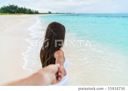 POV of couple walking - boyfriend following girlfriend holding hand on beach POV of couple walking - boyfriend following girlfriend holding hand on beach 55918730