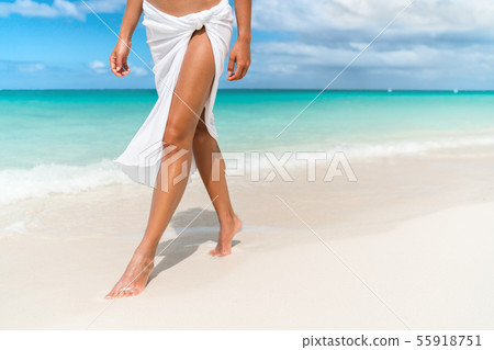 Caribbean beach travel - woman legs closeup walking on sand Caribbean beach travel - woman legs closeup walking on sand 55918751