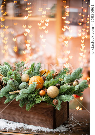 Christmas mood. Beautiful festive arrangement of fresh spruce in a rustic wooden box. Bokeh hearts Christmas mood. Beautiful festive arrangement of fresh spruce in a rustic wooden box. Bokeh hearts 55920961