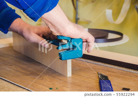 The carpenter processes the blanks for the manufacture of furniture The carpenter processes the blanks for the manufacture of furniture 55922294
