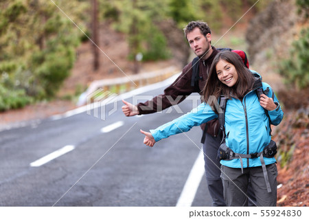 Travel hikers couple hitchhiking on road trip Travel hikers couple hitchhiking on road trip 55924830