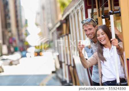 San Francisco cable car couple taking phone selfie San Francisco cable car couple taking phone selfie 55924890