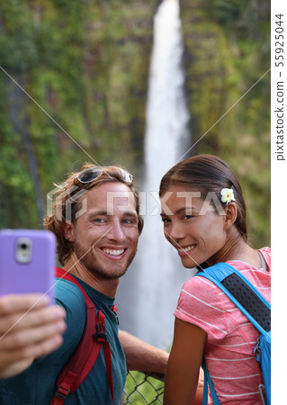 Hawaii couple tourists taking travel phone selfie 55925044