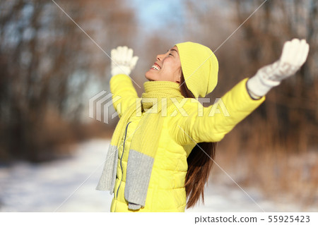Happy winter freedom carefree woman on snow day 55925423