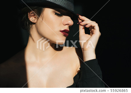dramatic portrait of sexy young girl in black hat with red lipstick 55926865