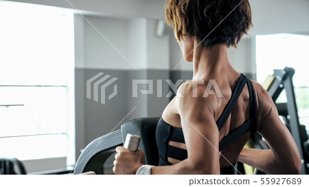 Sportive woman is doing exercises for spine muscles on block simulator Sportive woman is doing exercises for spine muscles on block simulator 55927689