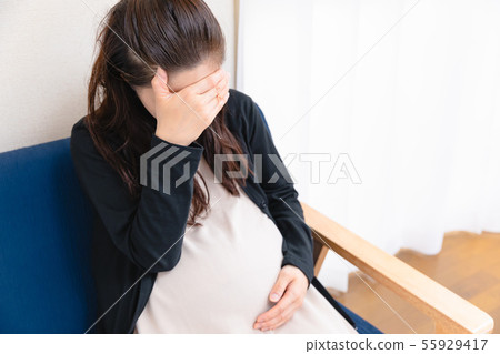 Pregnant woman 4 covering her face 55929417