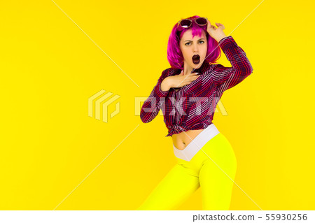 Shocked girl portrait on yellow background. Crazy 55930256