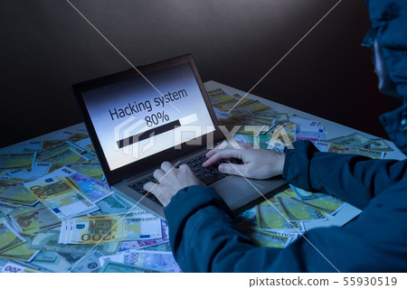 Anonymous hacker programmer uses a laptop to hack 55930519